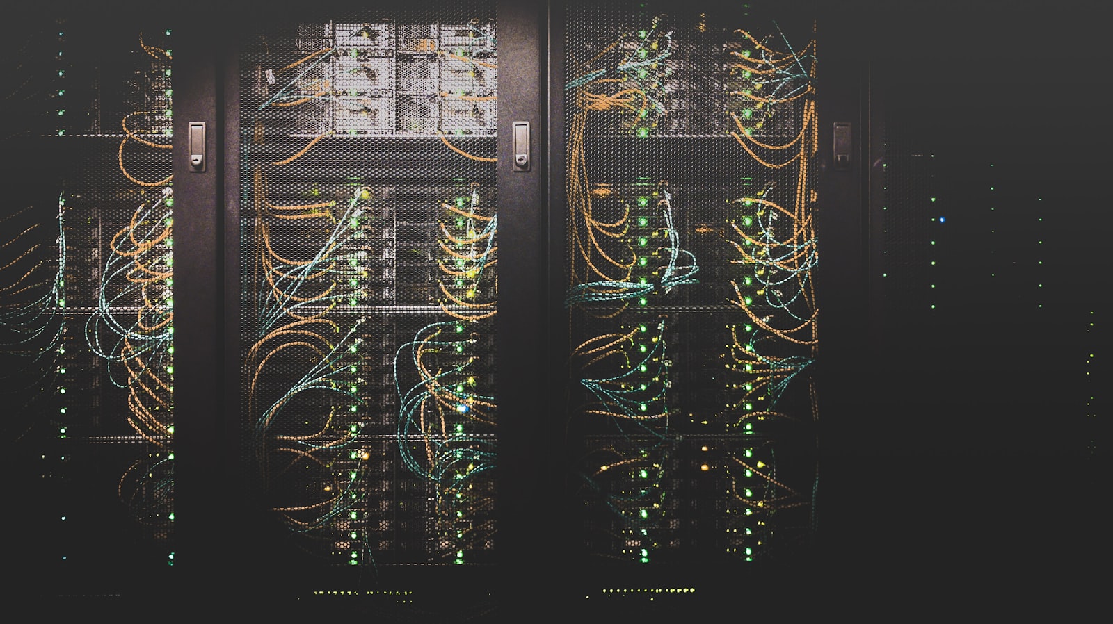 Rows of lit server racks in a data-hall aisle.